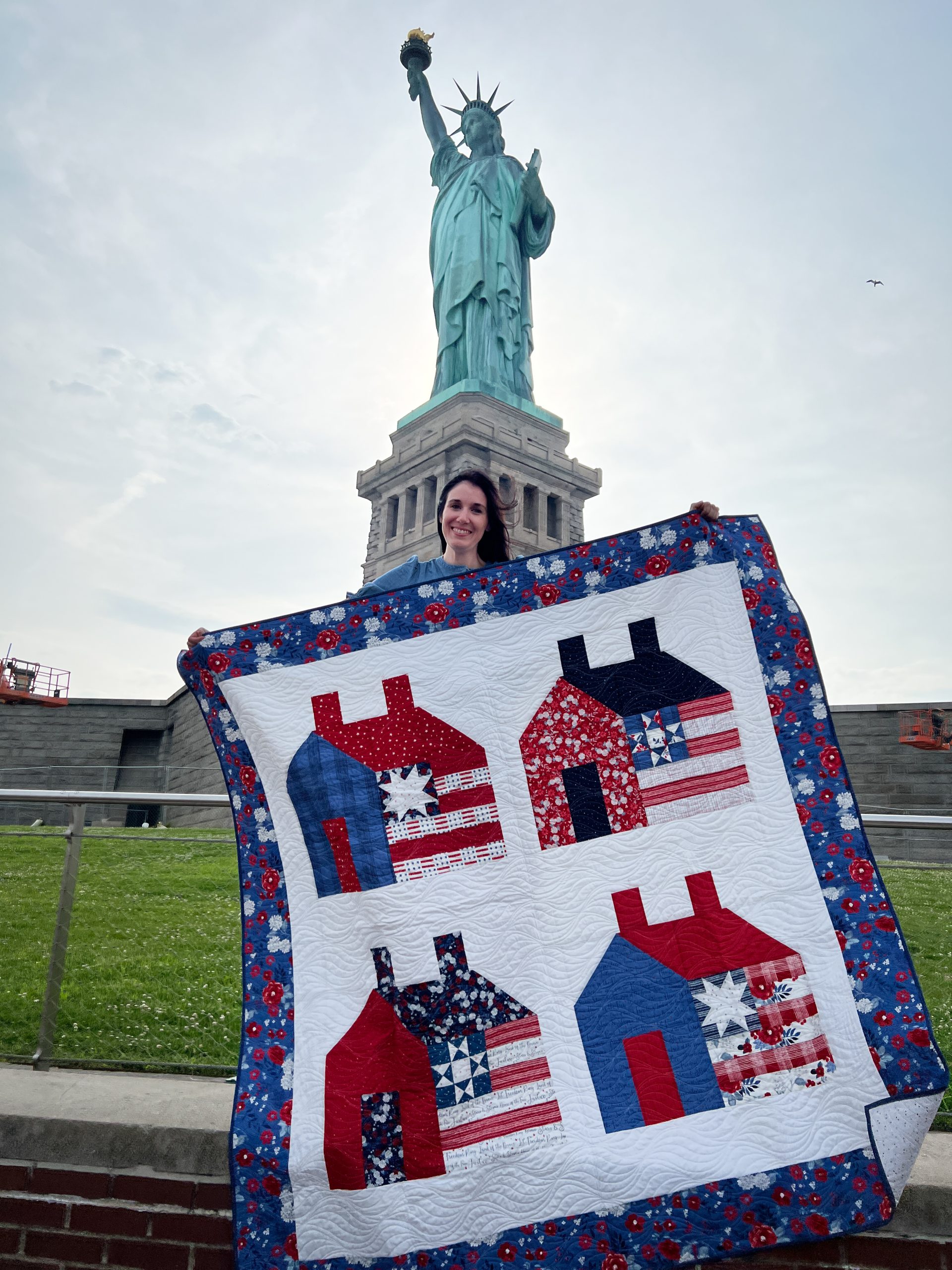 Libert home quilt posing in front of the Statue of Liberty